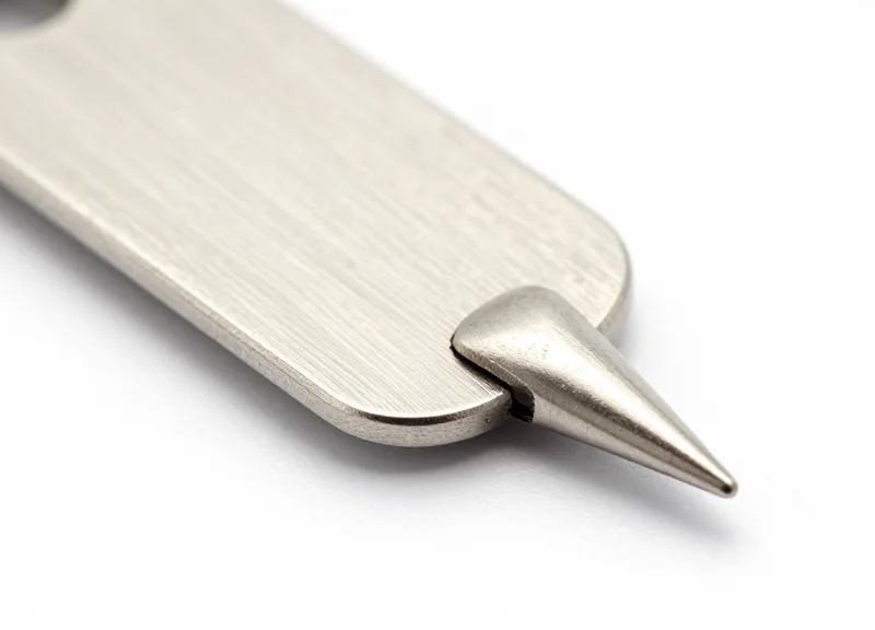 Close-up of an ultra-fine stainless steel security pin for delicate fabrics.