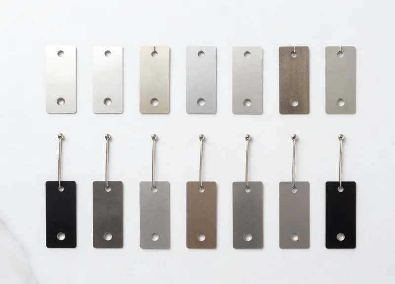 A collection of various professional garment security tags organized neatly on a flat surface.