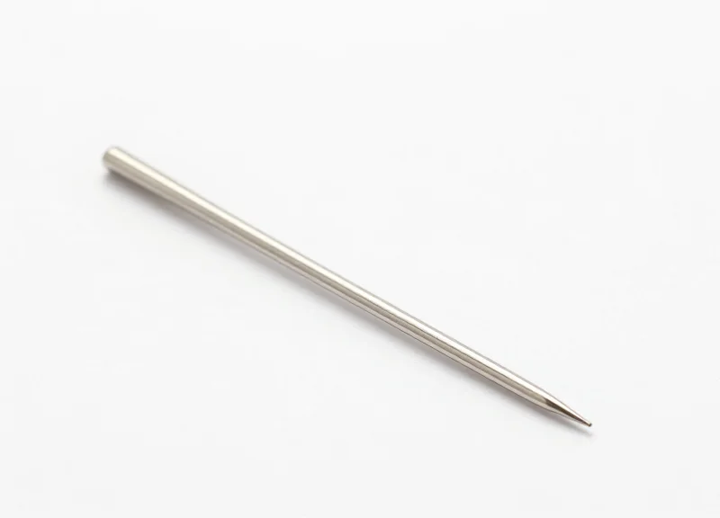 Macro close-up of an ultra-fine stainless steel pin for an EAS security tag.