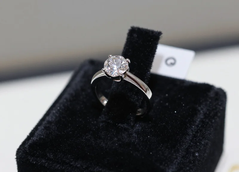 High-end diamond ring secured with a micro-tag inside a jewelry store display.