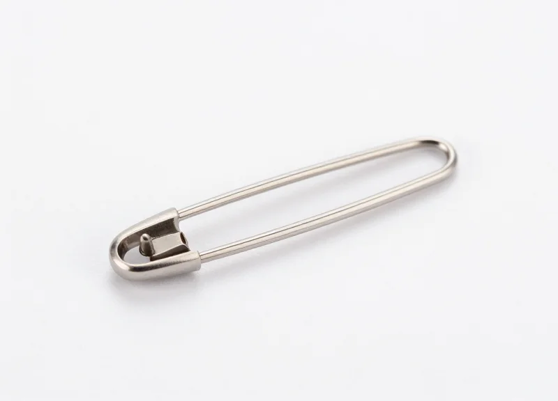 Macro view of a 15mm micro-EAS security pin on a white studio background.