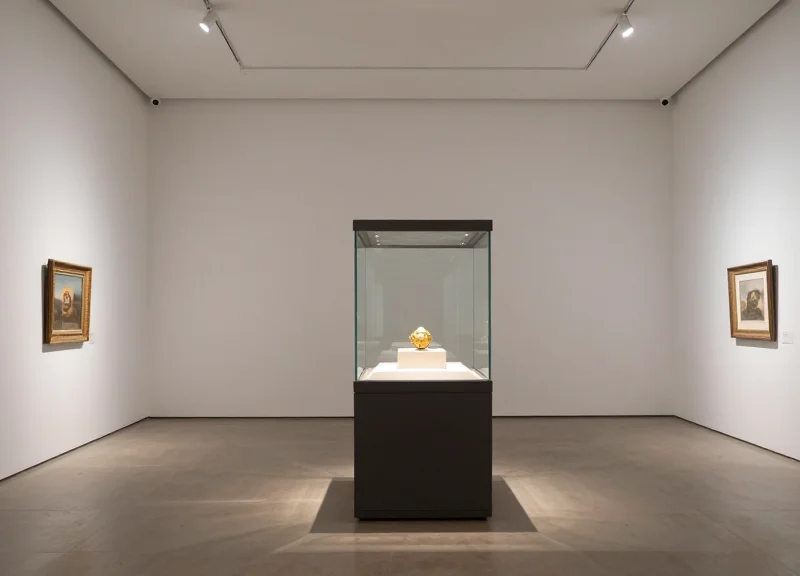 An elegant gallery exhibit showing art with invisible security integration.