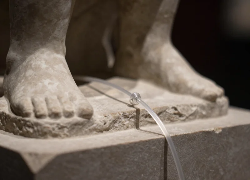 Macro shot of a security lanyard attached to a stone sculpture base