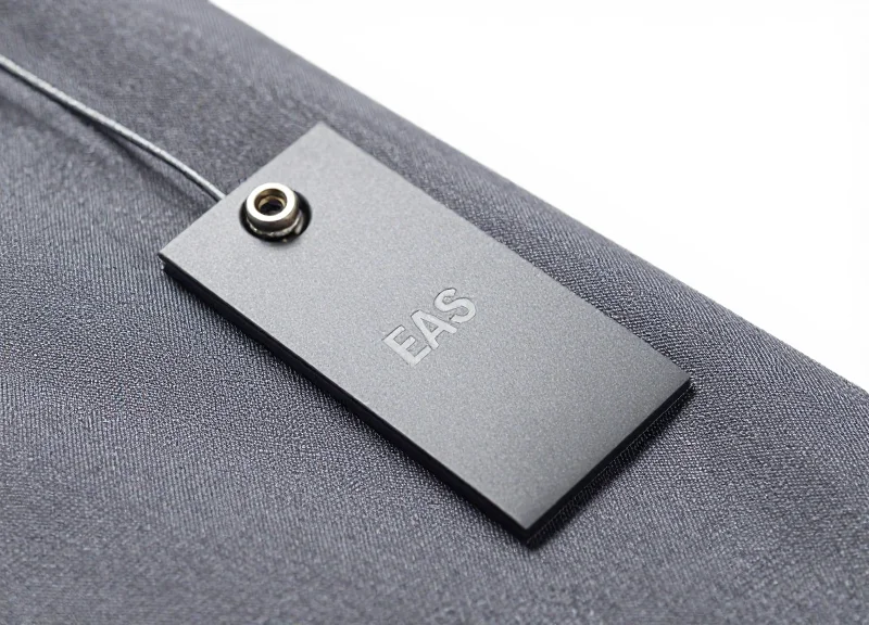 Close up of an advanced EAS security tag on clothing fabric