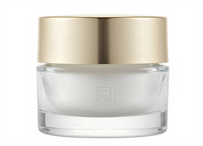 Luxury glass cosmetic jar with a tiny transparent security label on a white background.