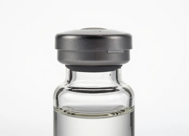 Elegant skincare vial on a pure white background with a discreetly integrated security tag.