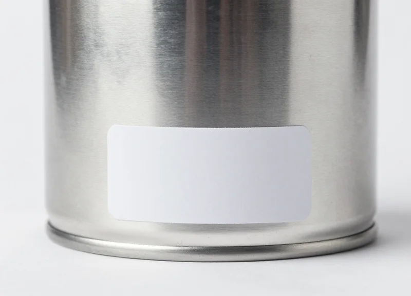 A security tag applied to the bottom base of a supplement can to avoid covering labels.