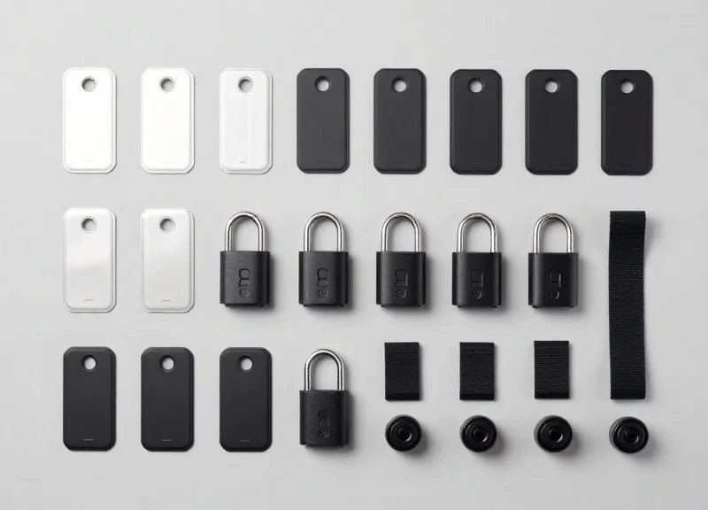 A variety of different security tags for cameras and lenses arranged neatly on a surface.