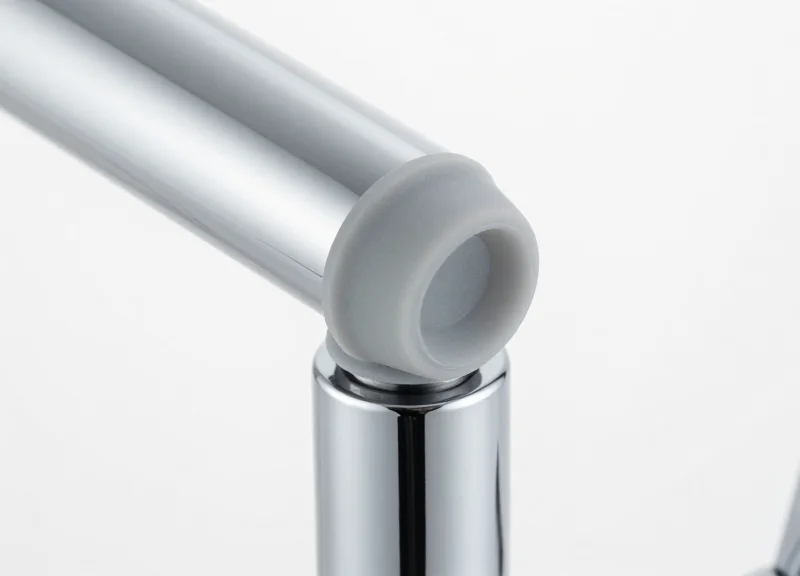 Macro view of a chrome faucet with a protective silicone-padded security sensor.