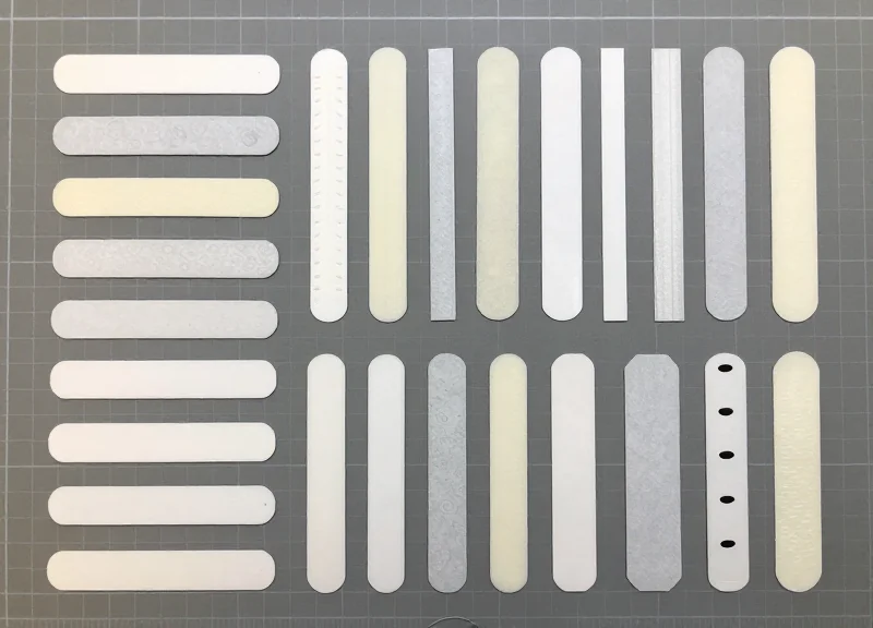 A variety of library security EM strips and tapes arranged neatly on a work surface.