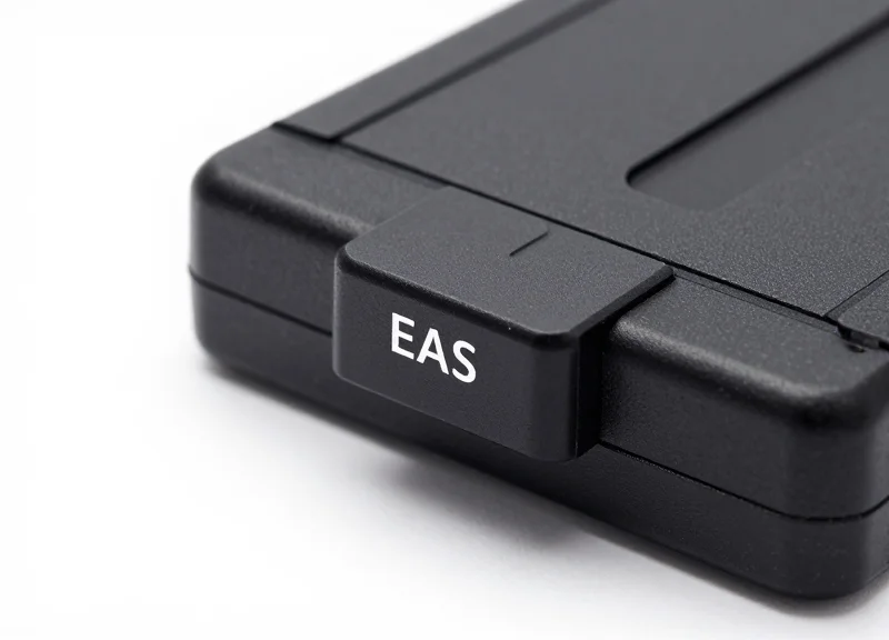 Close-up of a professional EAS security tag attached to a battery product.
