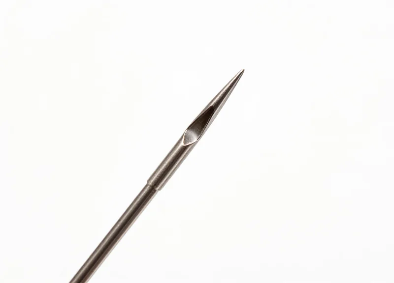 Macro view of an ultra-fine needle-style security pin on a white background.