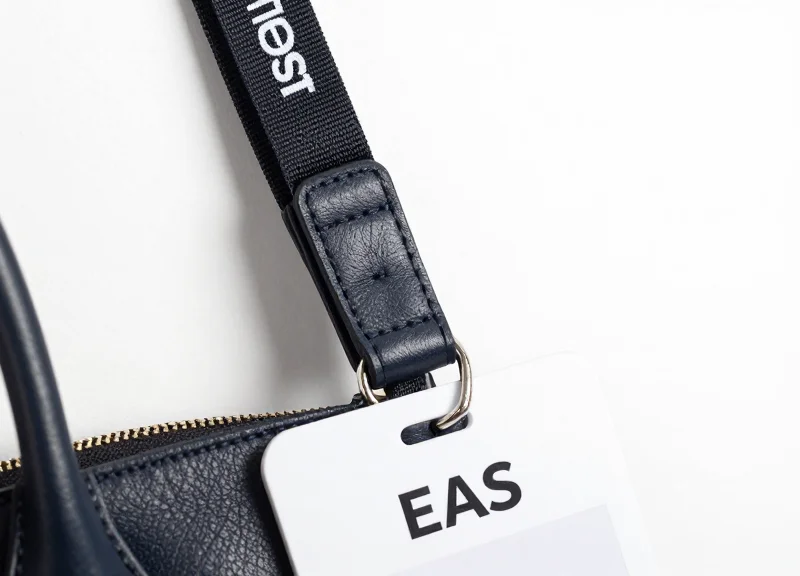 Close-up of a soft EAS lanyard tag attached to a high-quality leather strap, highlighting the gentle material contact.