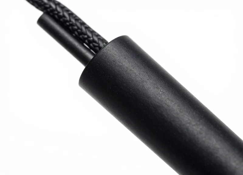 A detailed close-up of a specialized small sensor cable for retail security.