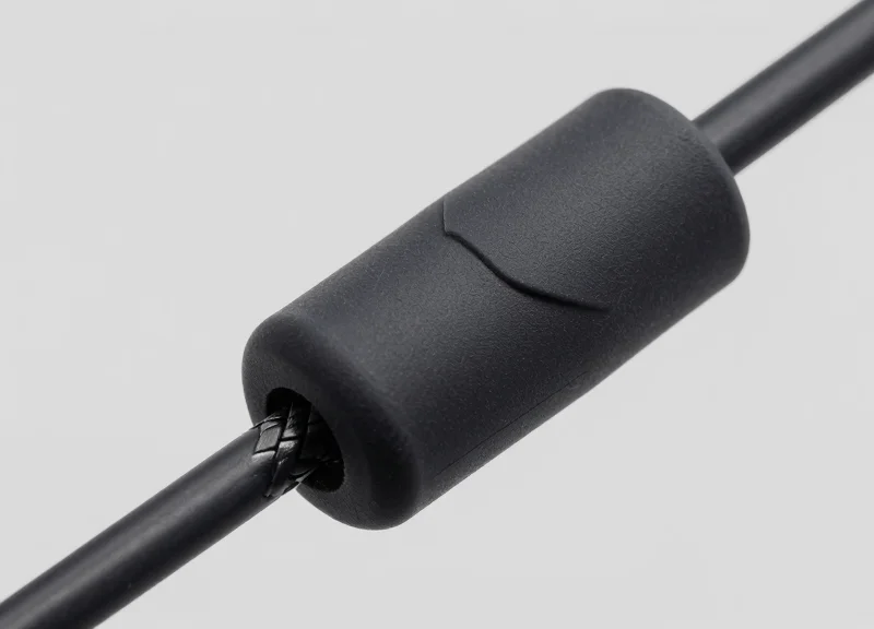 Detailed macro shot of a rubber-coated security lanyard cable designed for surface protection.