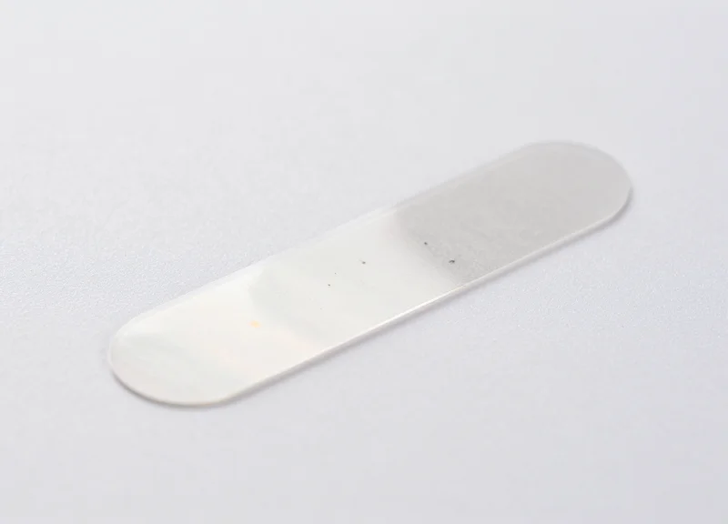 Macro shot of a high-tech transparent EAS security label emphasizing its smooth surface.