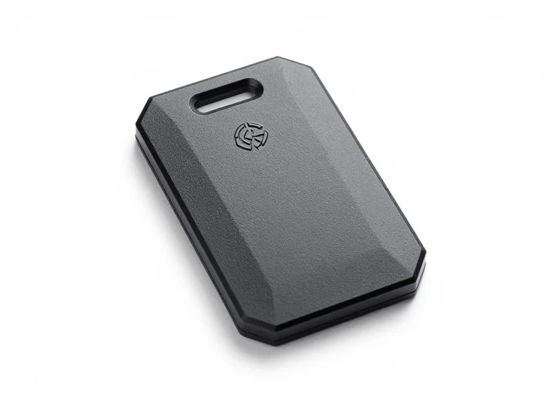 Close-up of a sleek, matte black hybrid EAS and RFID security hard tag on a white background
