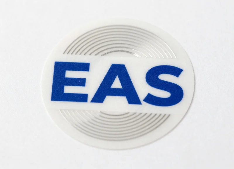 Close-up of a high-tech EAS soft security label showing its internal circuit patterns.