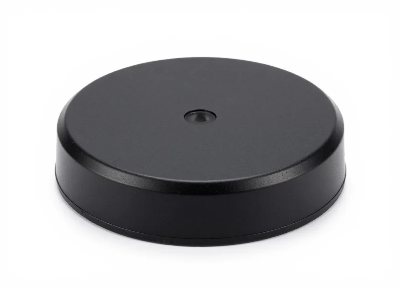 A traditional black magnetic EAS security base used for retail protection.