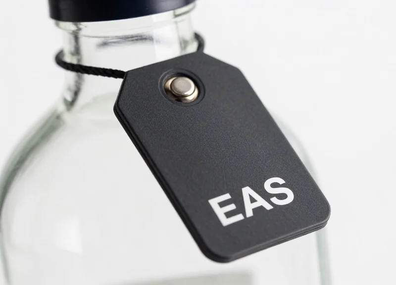 Macro shot of an advanced EAS security tag on a bottle neck