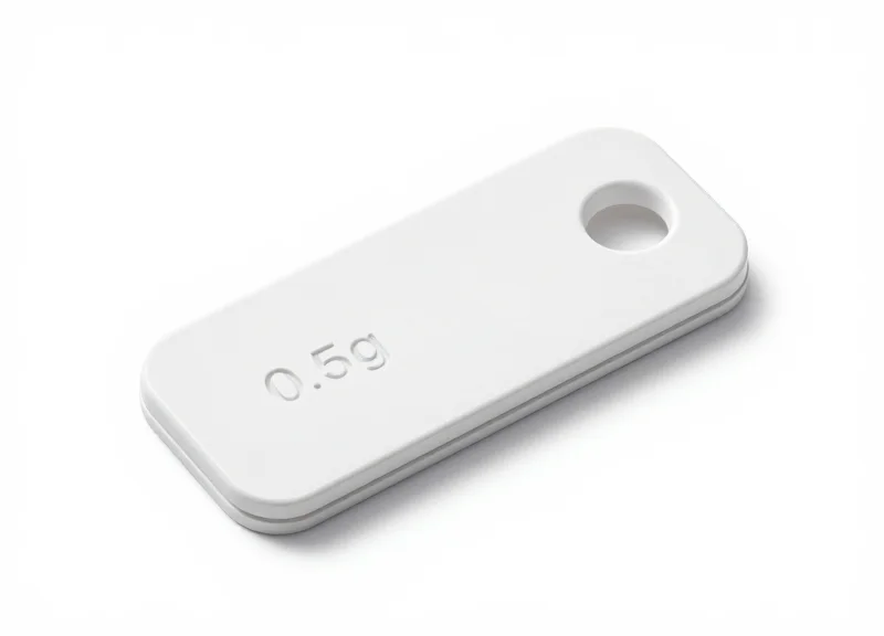 A macro studio shot of a tiny 0.5g optical security tag on a white background.