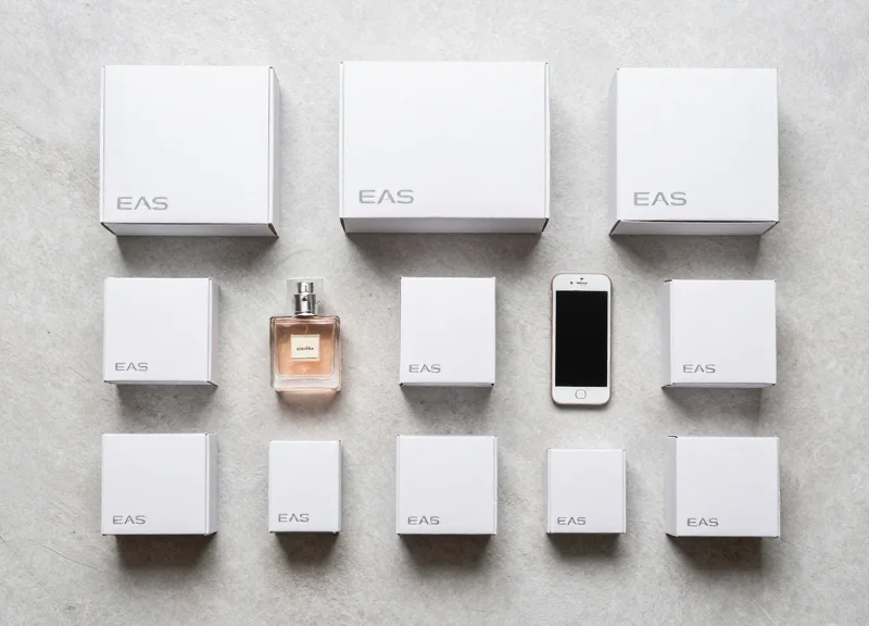 A variety of different sized and shaped EAS safer boxes organized on a neutral surface.
