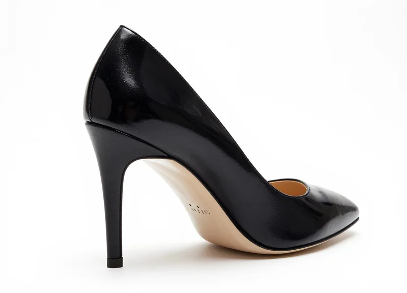 A designer shoe with a discreetly integrated security tag on a white background.
