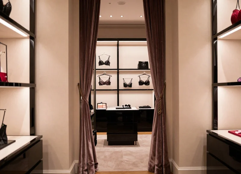Luxury retail fitting room with elegant decor and soft lighting representing a modern boutique environment.