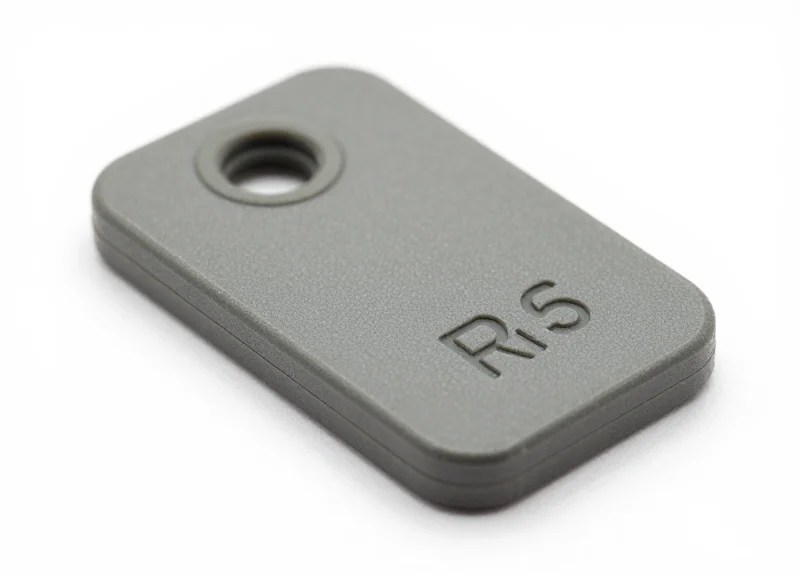 A close-up of a rugged, chemical-resistant industrial RFID tag on a clean white background.