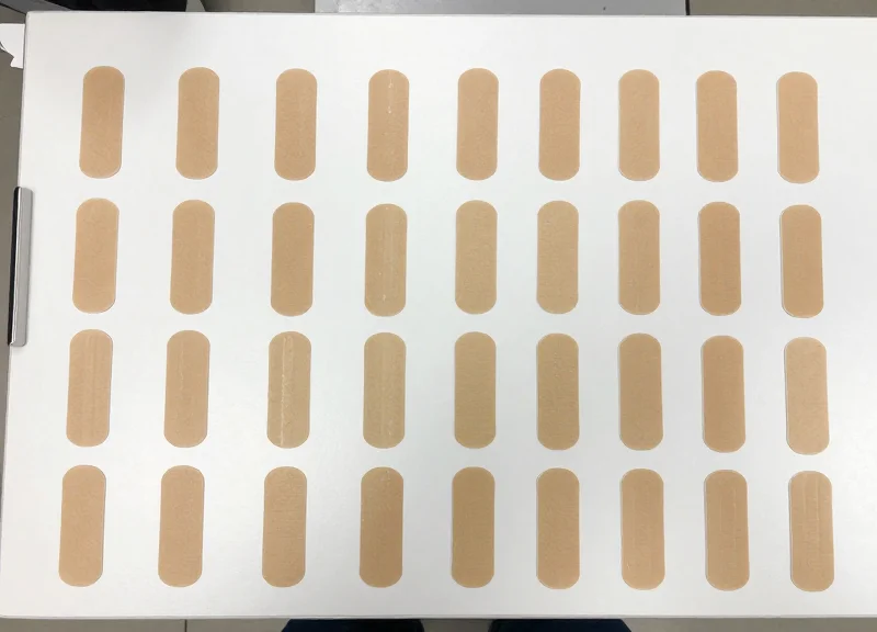 A collection of numerous smart-disposable sensor tags neatly organized on a surface.