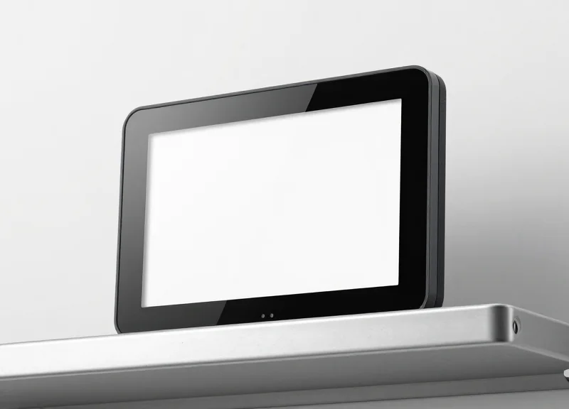 A sleek white electronic shelf label with a blank e-ink screen mounted on a minimalist metal shelf.