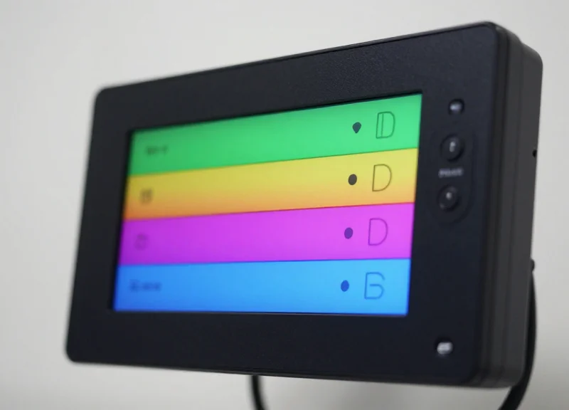 Close-up view of a medical-grade electronic shelf label with a high-contrast e-ink display and colored status indicators.