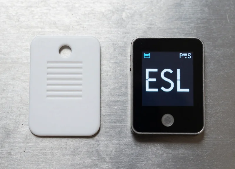 Side-by-side comparison of a traditional RFID tag and a modern ESL device on an industrial surface.