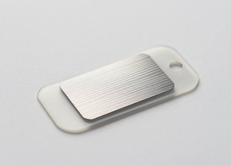 Close-up of a high-frequency RFID tag used for tracking automotive spare parts.