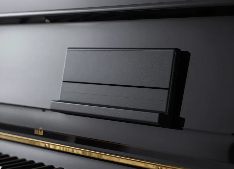 A sleek digital price tag mounted on the side of a polished black piano.