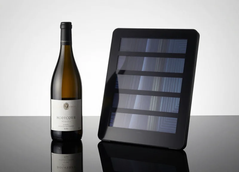 Premium wine bottle next to a high-resolution electronic shelf label displaying visual graphics