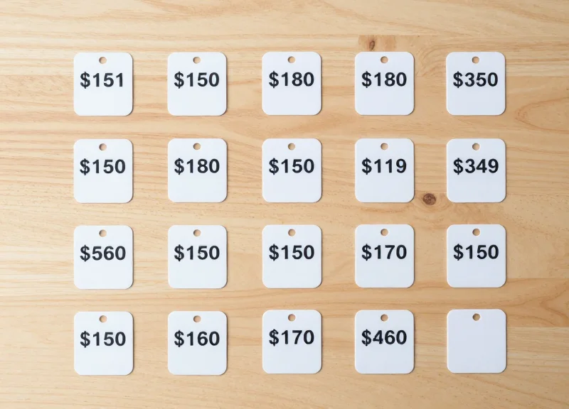 A collection of small electronic shelf labels neatly arranged on a wooden surface representing shelf density.