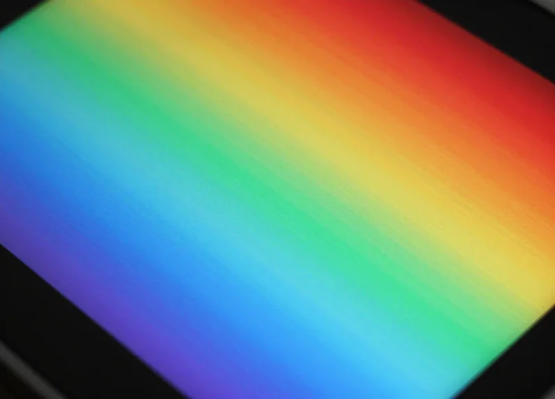 Close-up of a high-resolution full-color e-paper screen showing vivid pigment colors.